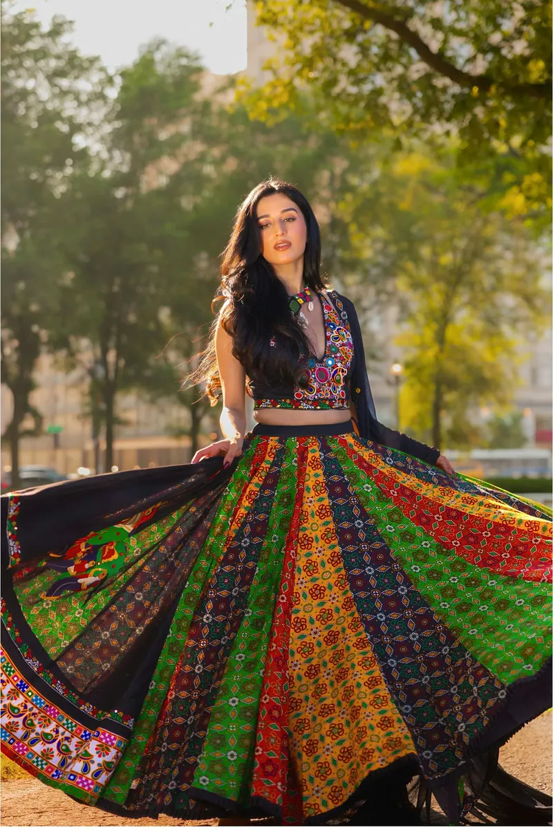 Woman twirling a colourful Navratri chaniya choli outdoors