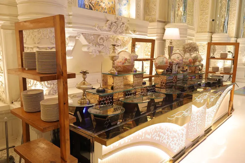 Buffet live counter with wooden plate racks and warm under-lighting
