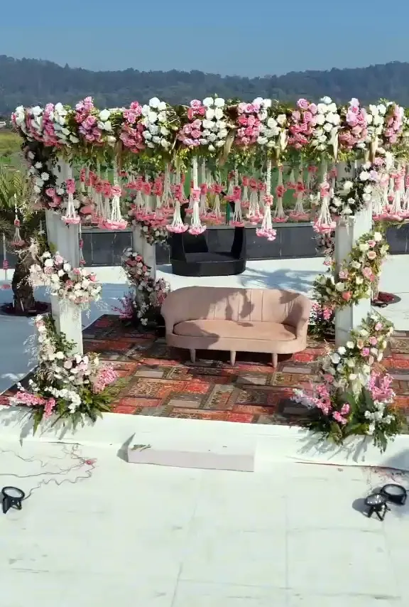Close view of a mandap canopy hung with pink and white flower strands