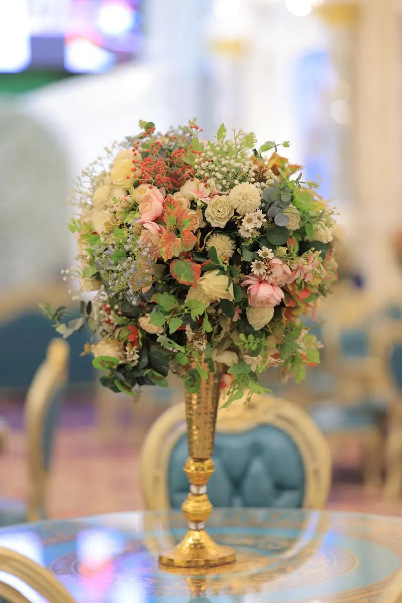 Pastel rose and hydrangea centrepiece on a slim gold stand