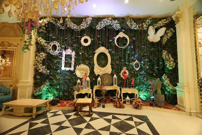 Greenery photo wall styled with white vintage frames, a butterfly and a flamingo
