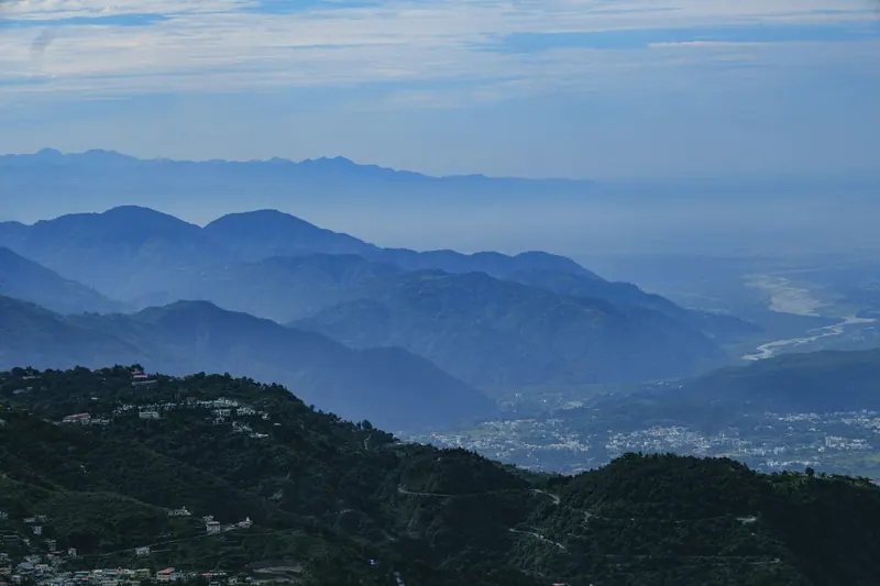 Layered blue ridges of the Himalayan foothills seen from Mussoorie